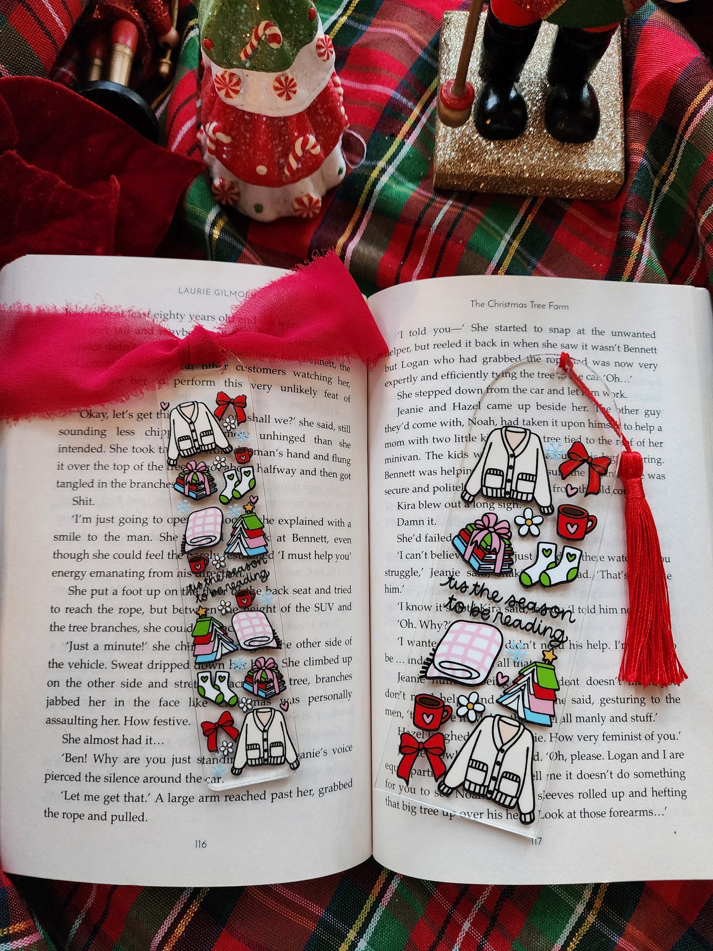 Decorative bookmarks with colorful designs on an open book against a plaid fabric background.