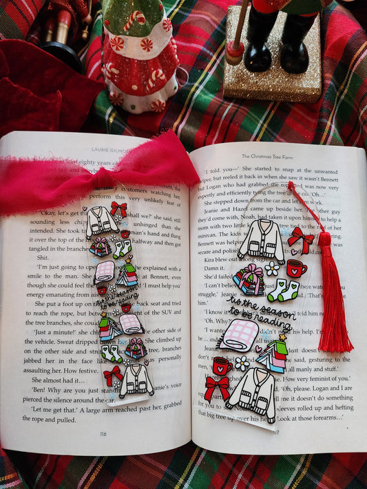 Decorative bookmarks with colorful designs on an open book against a plaid fabric background.