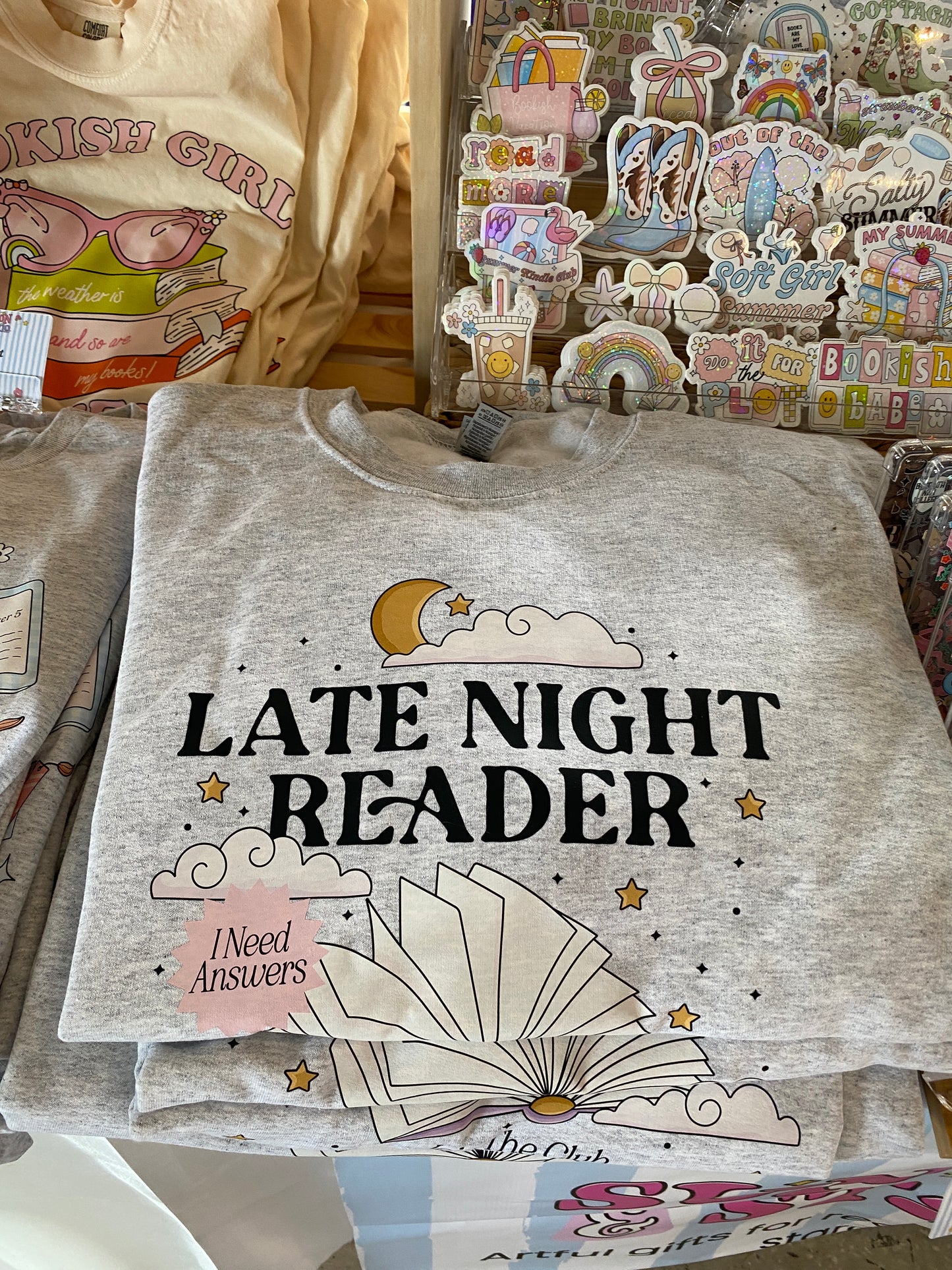 Late Night Reader Sweatshirt folded in a pile on a table 